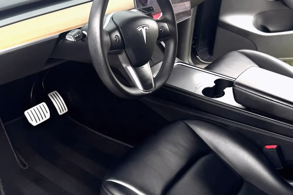 A spotless Tesla interior with wood trim after a deep clean